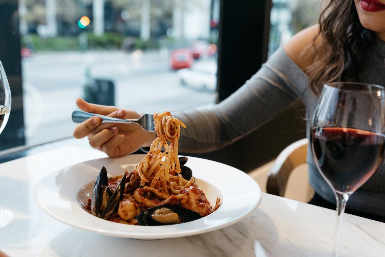 Art Series - The Chen Box Hill Esterno foto A woman eating a pasta dish